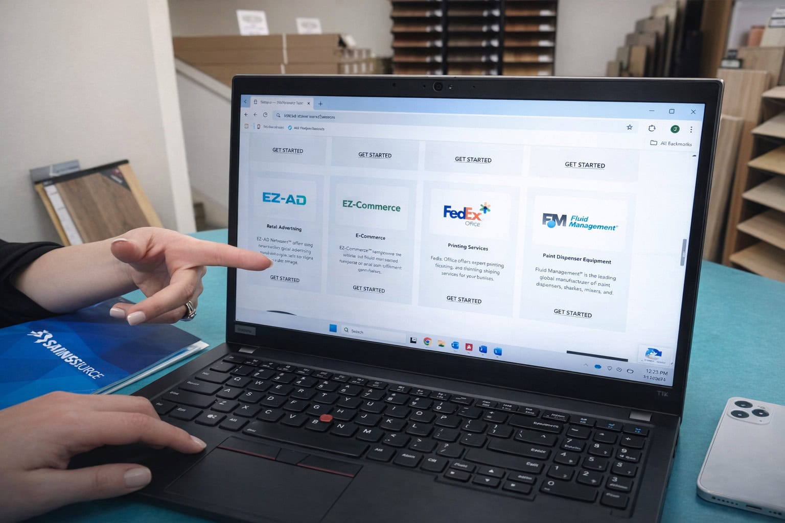 Person pointing at business service options on laptop screen.