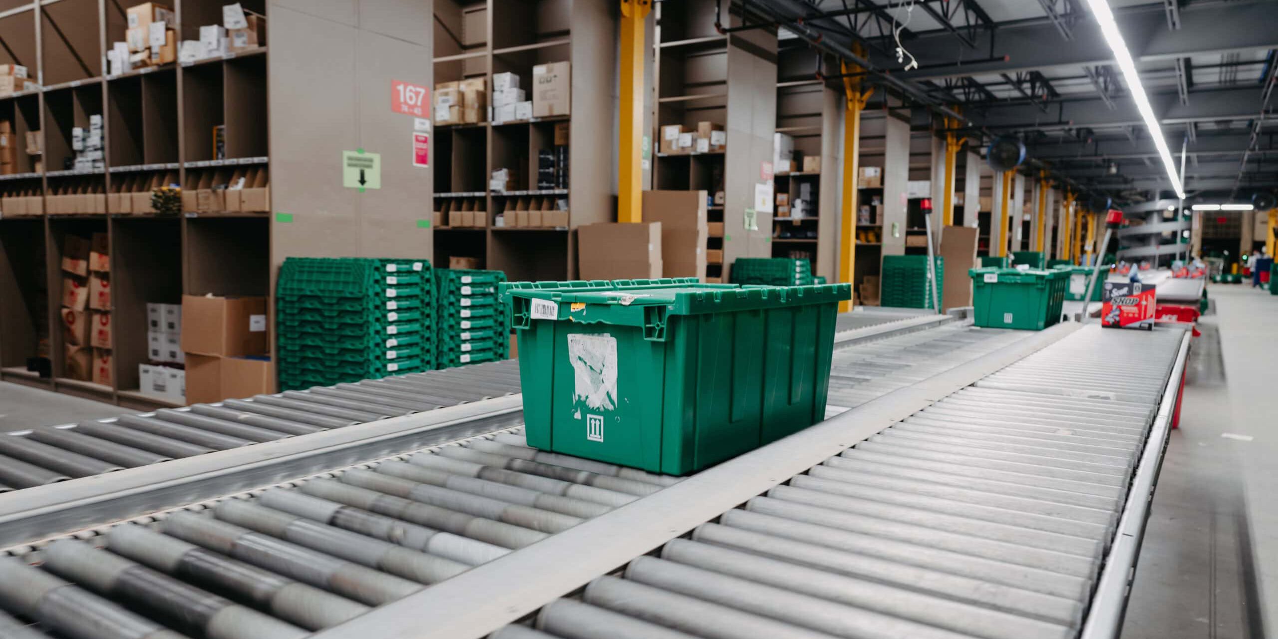 Green bin on warehouse conveyor belt
